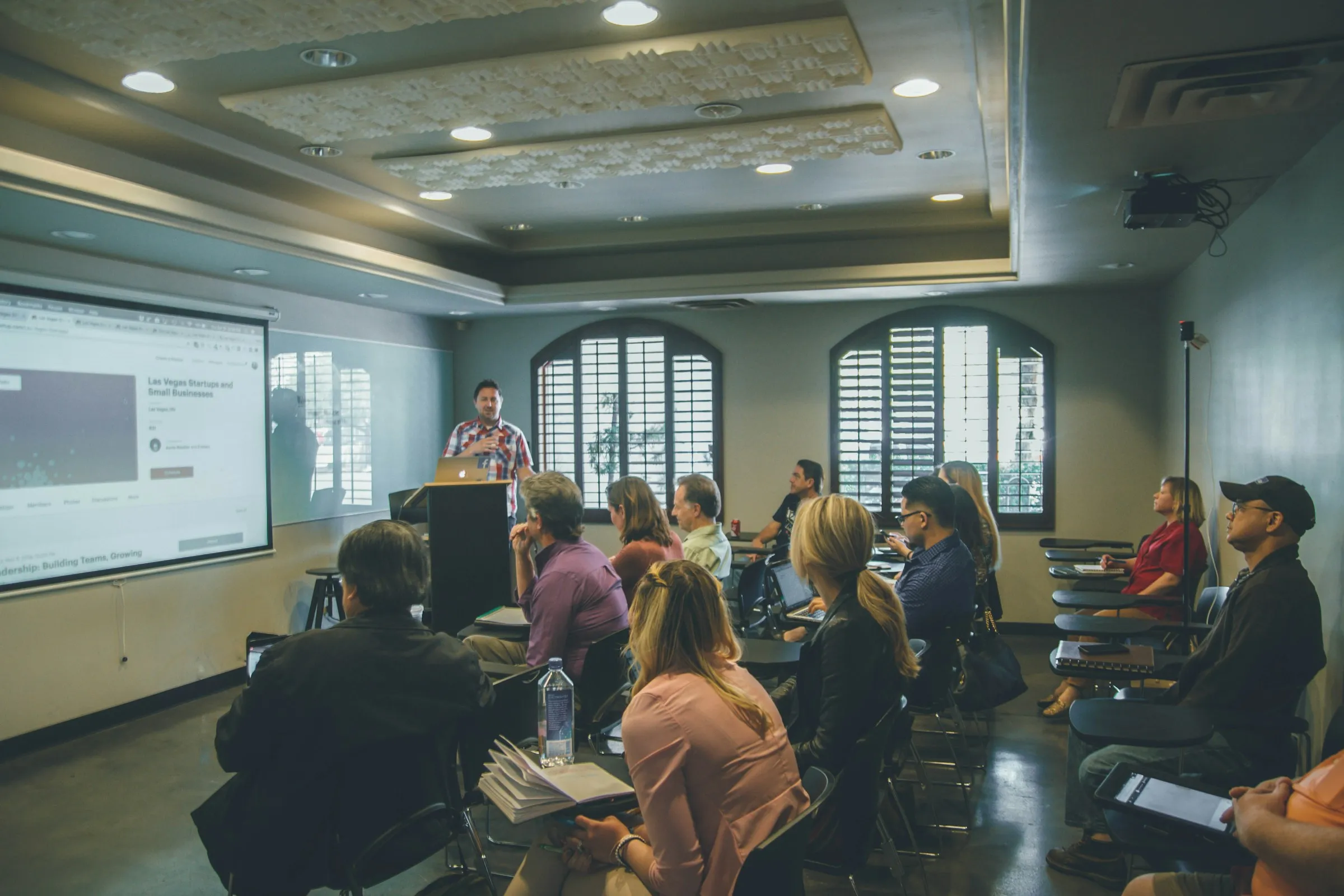 Trainer presenting to adult learners in a classroom