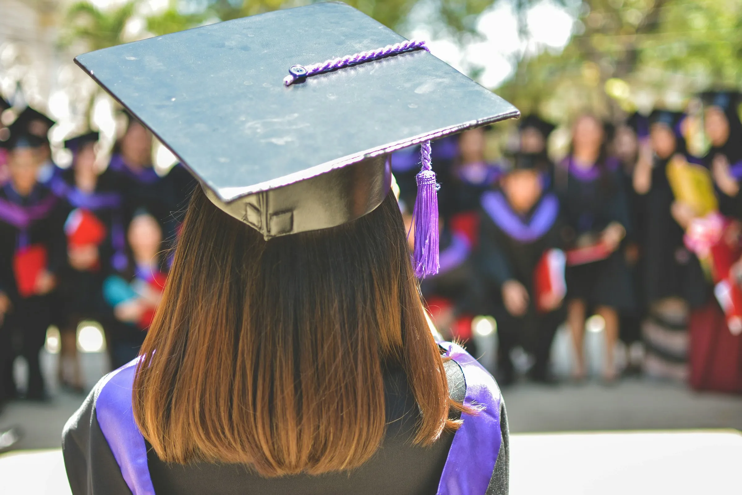 Graduate in a cap and gown at a ceremony