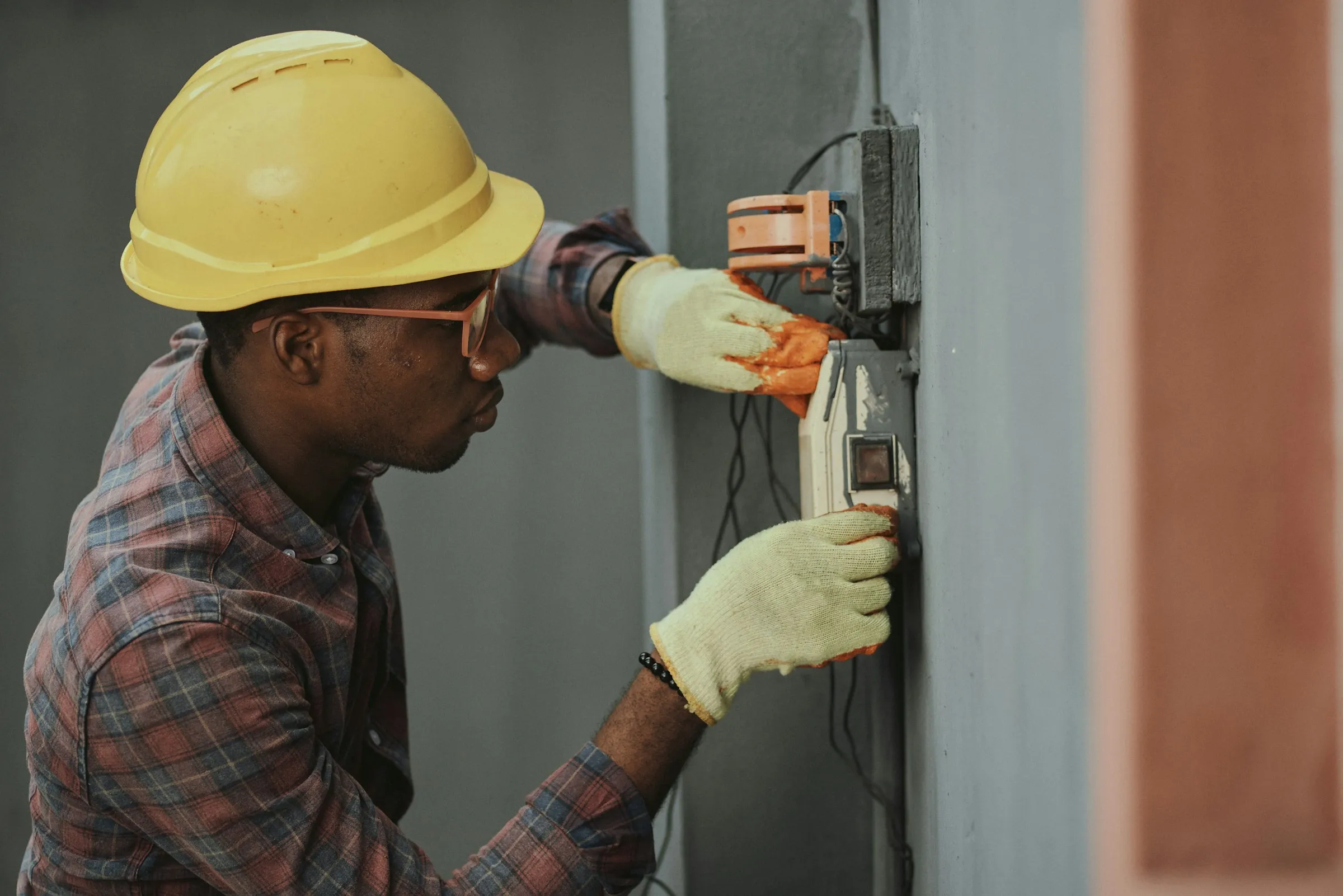 Technician in a hard hat taking a meter reading