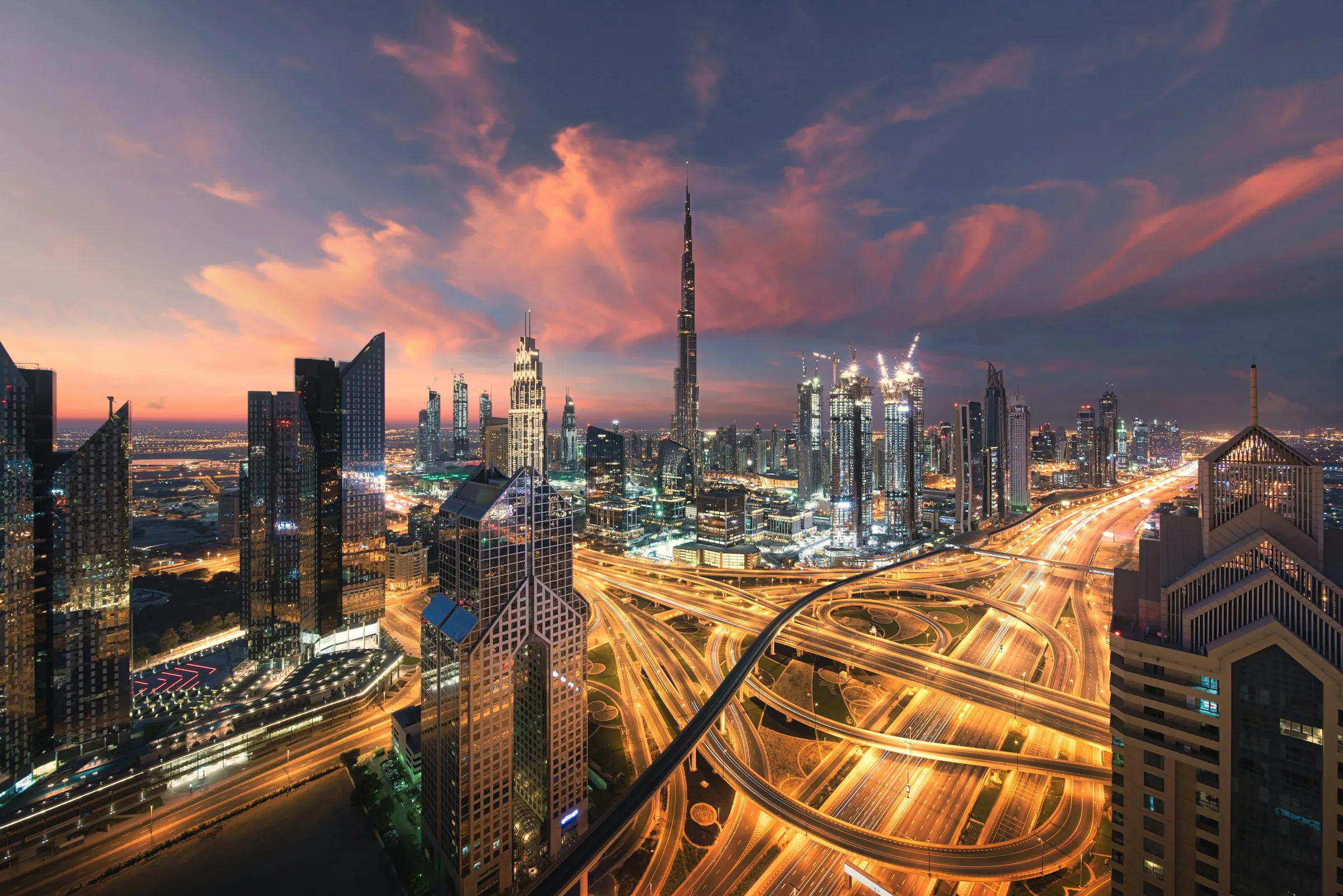Dubai skyline at dusk with light trails on the highway
