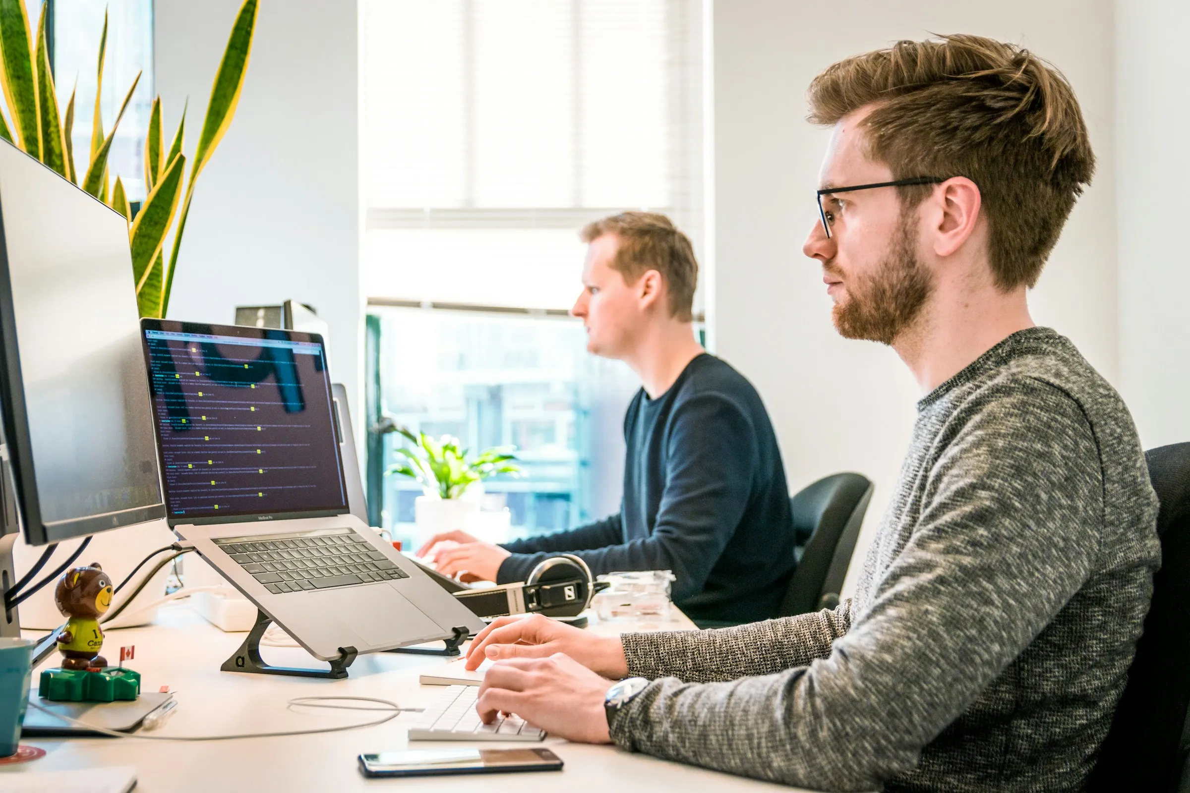 Developers working at computers in a bright office