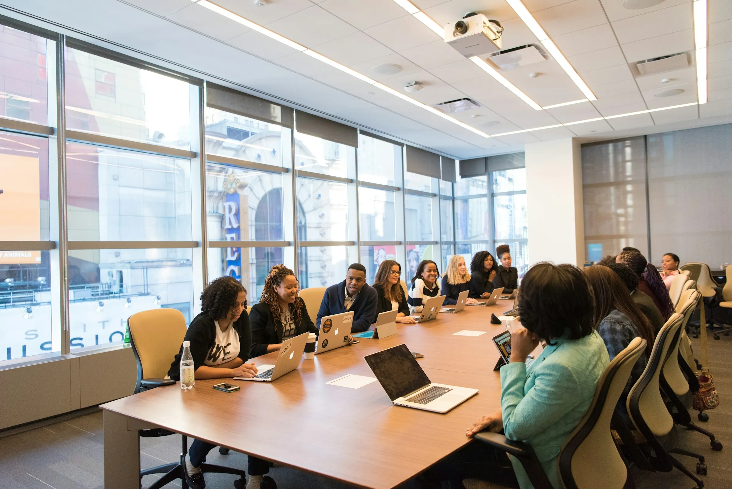 Large team meeting in a bright conference room