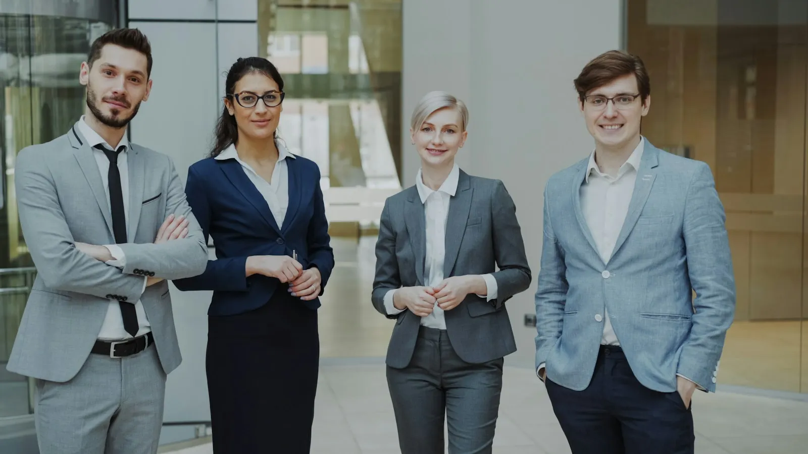 Four professionals standing together in an office