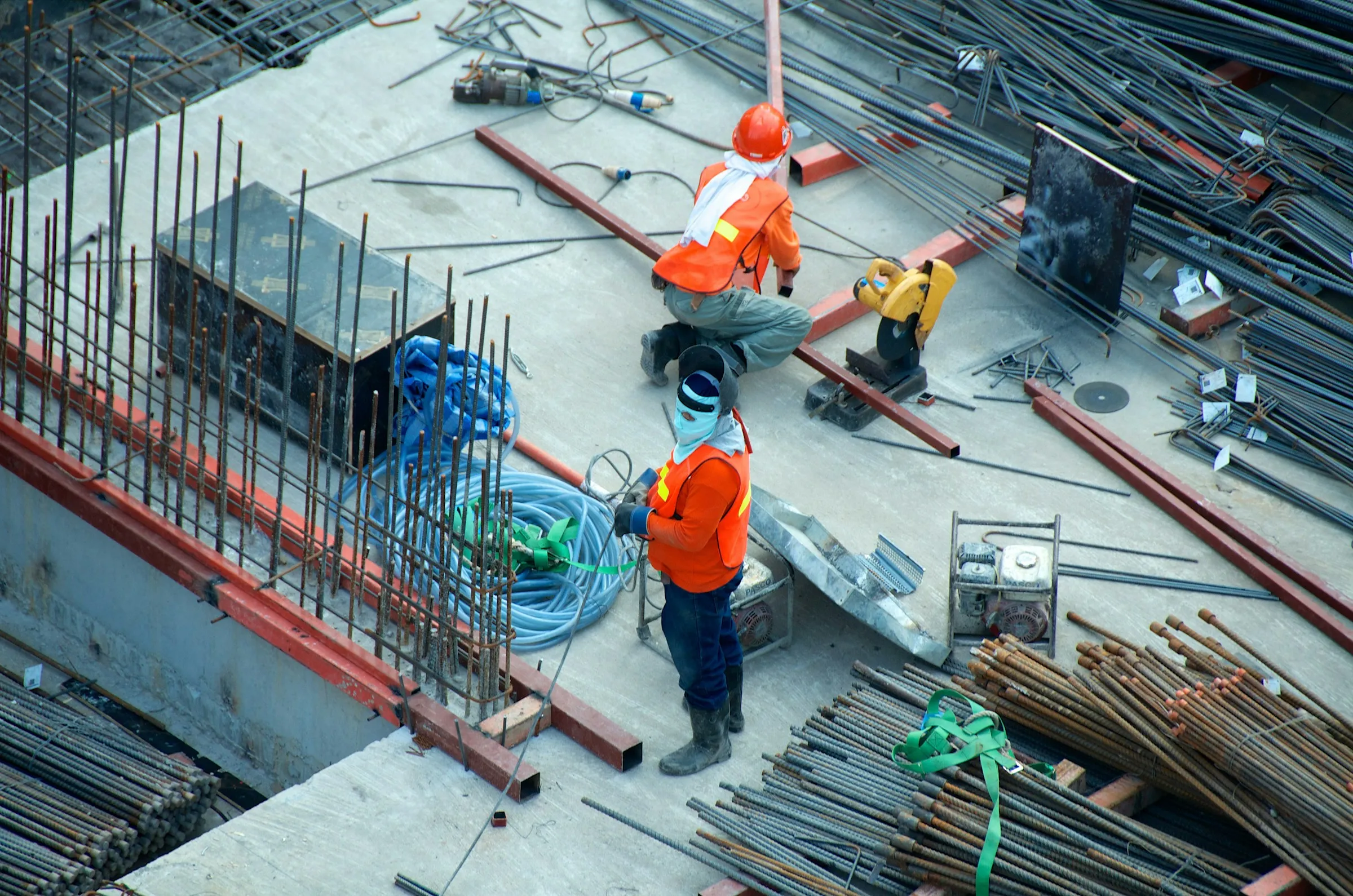 Workers in safety gear on a construction site seen from above