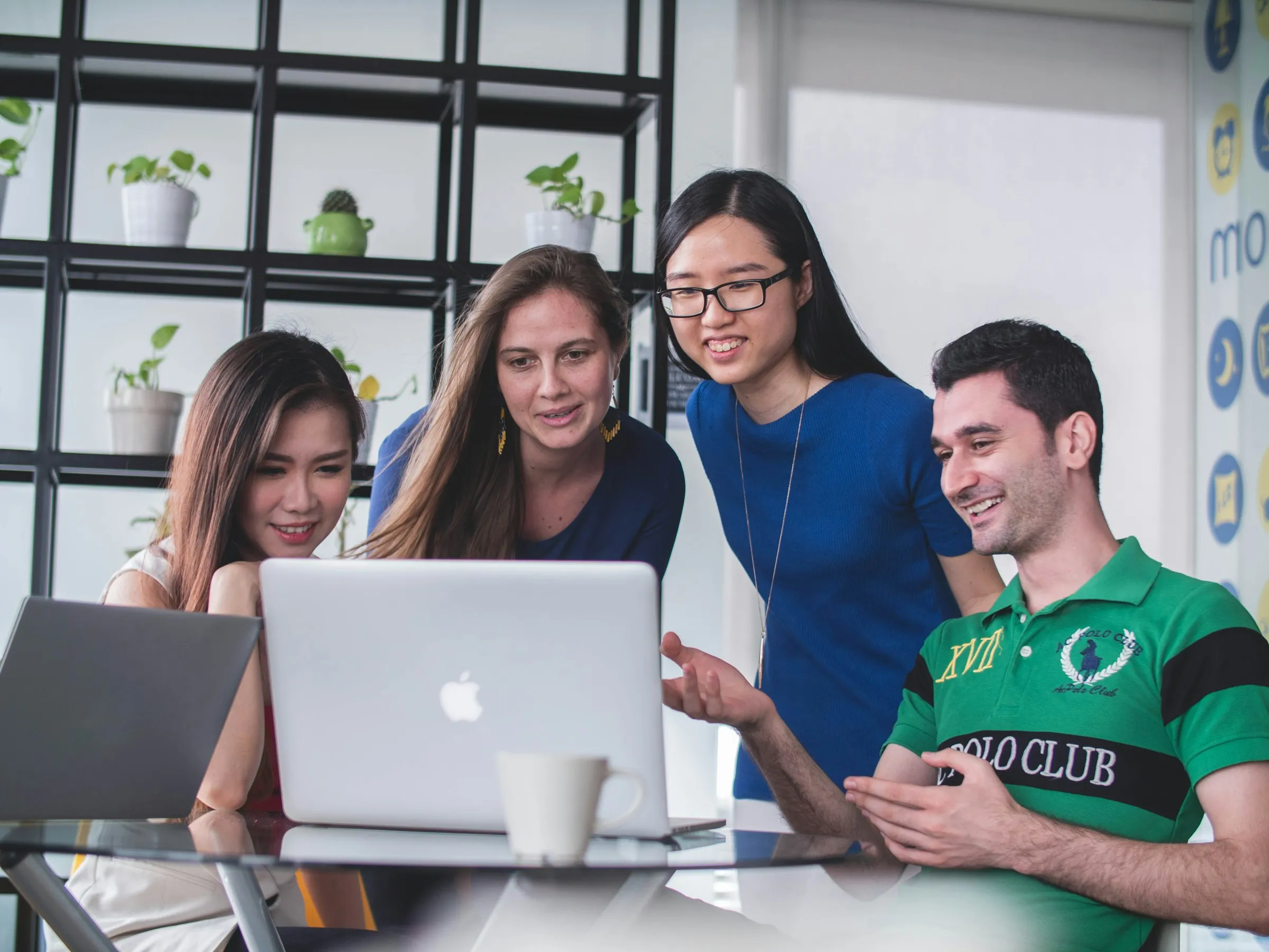 Group of colleagues looking at a laptop together