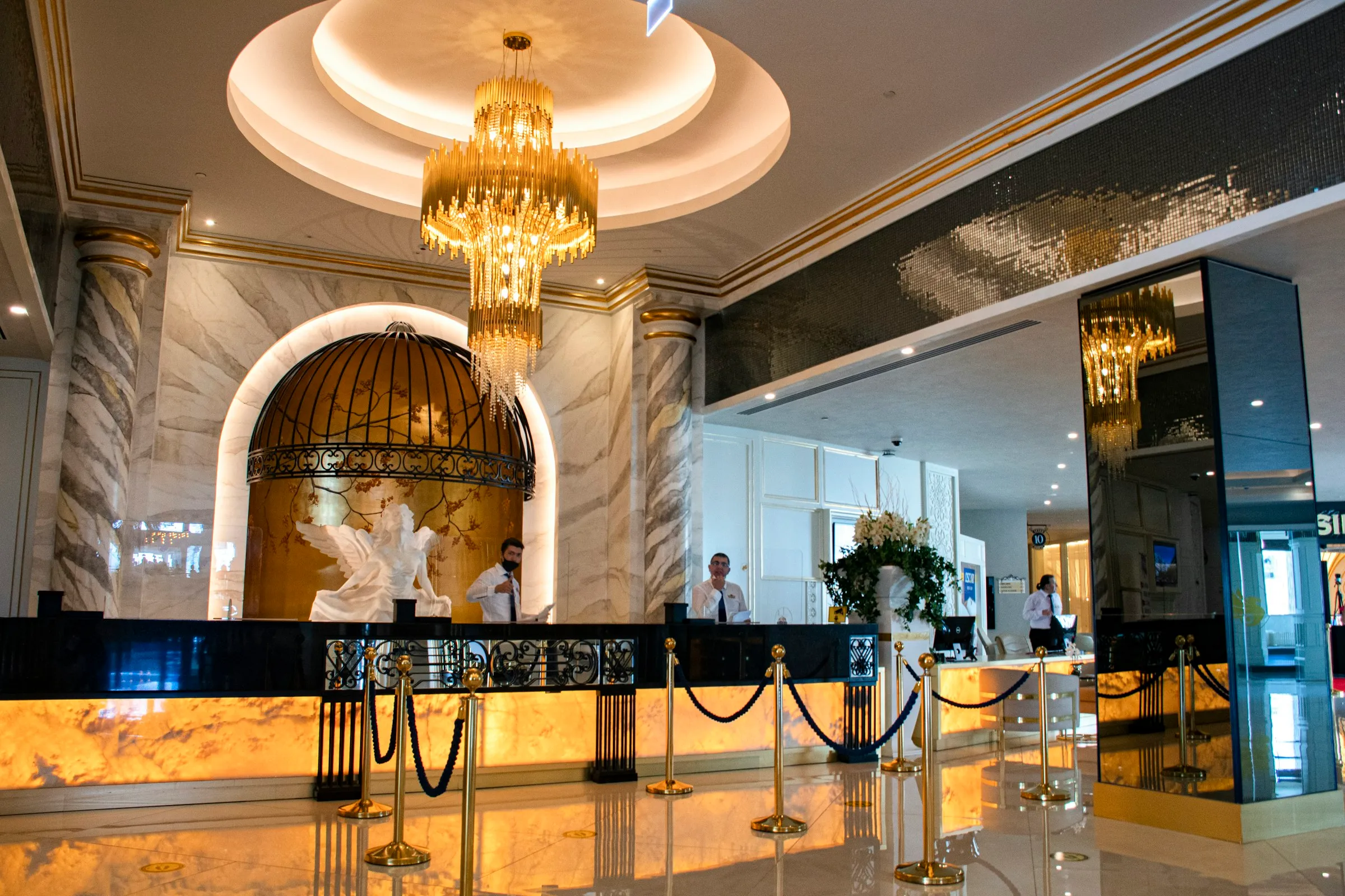 Grand hotel lobby with a chandelier and marble floor