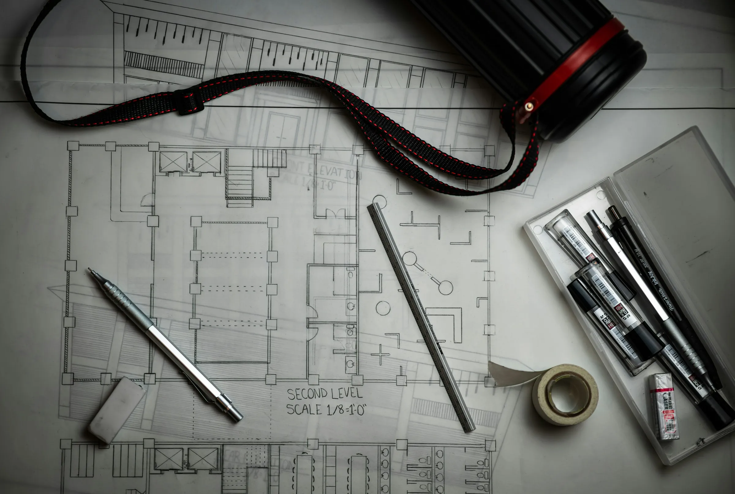 Architectural floor plans with pens and drawing tools