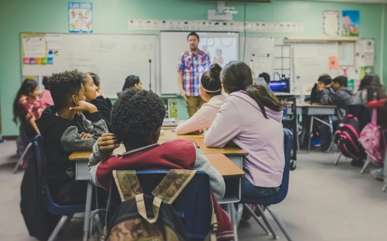 Teacher with pupils working in groups in a classroom